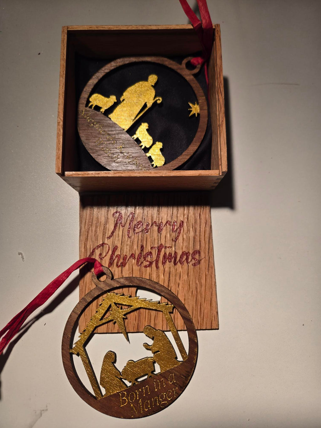 Laser-cut nativity ornament and Born in a Manger ornament with engraved Merry Christmas gift box