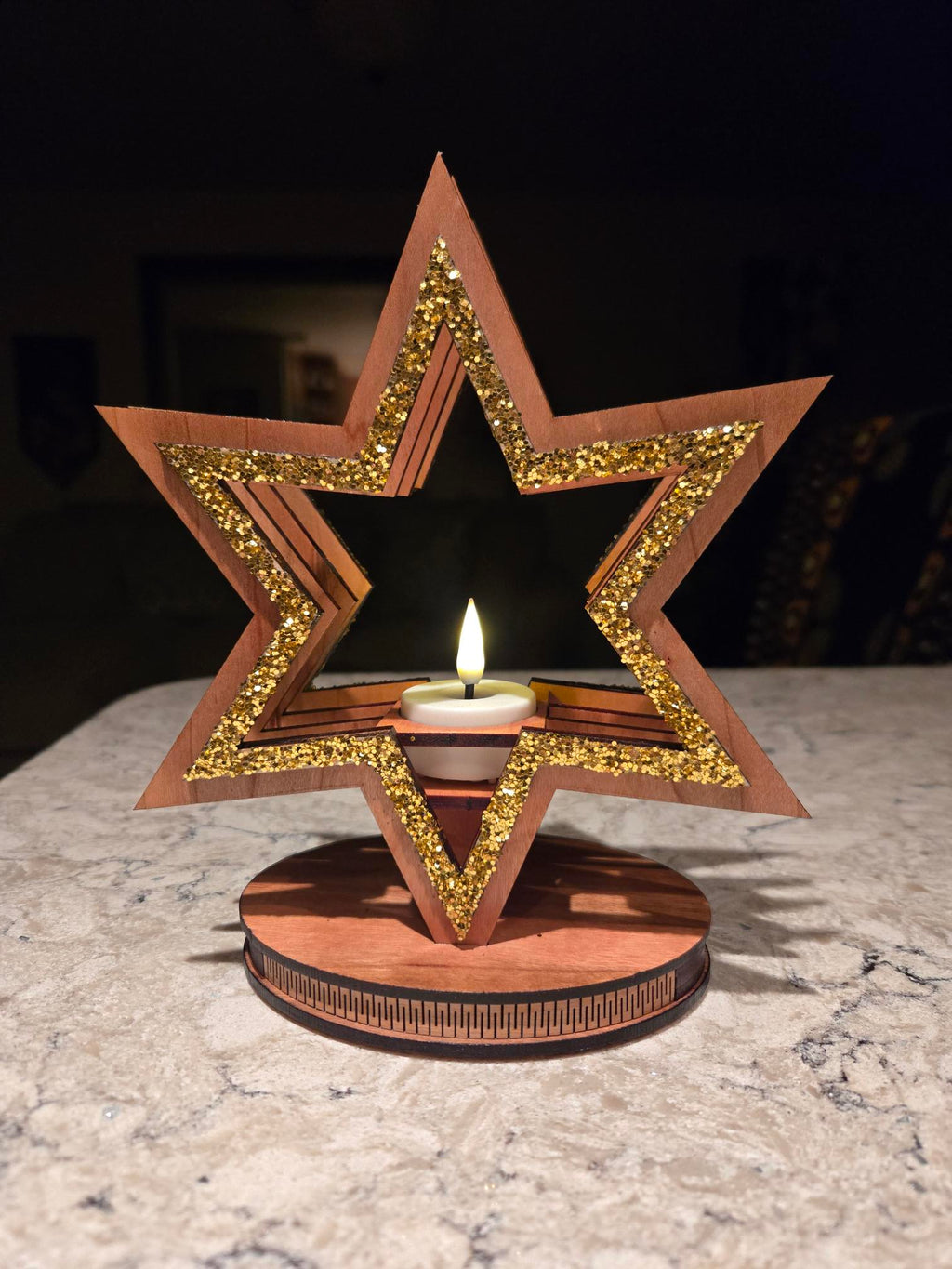 Single star candle holder side angle showing layered laser-cut wood depth