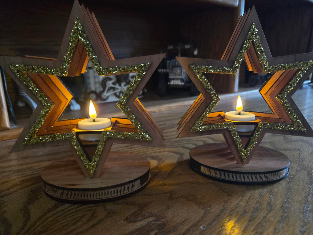 Pair of wood star candle holders glowing with tealights in evening light