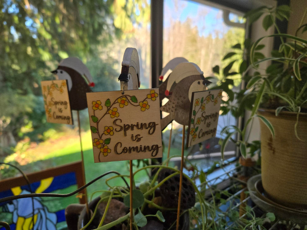 Chickadee garden stake close-up showing bird detail with Spring is Coming sign